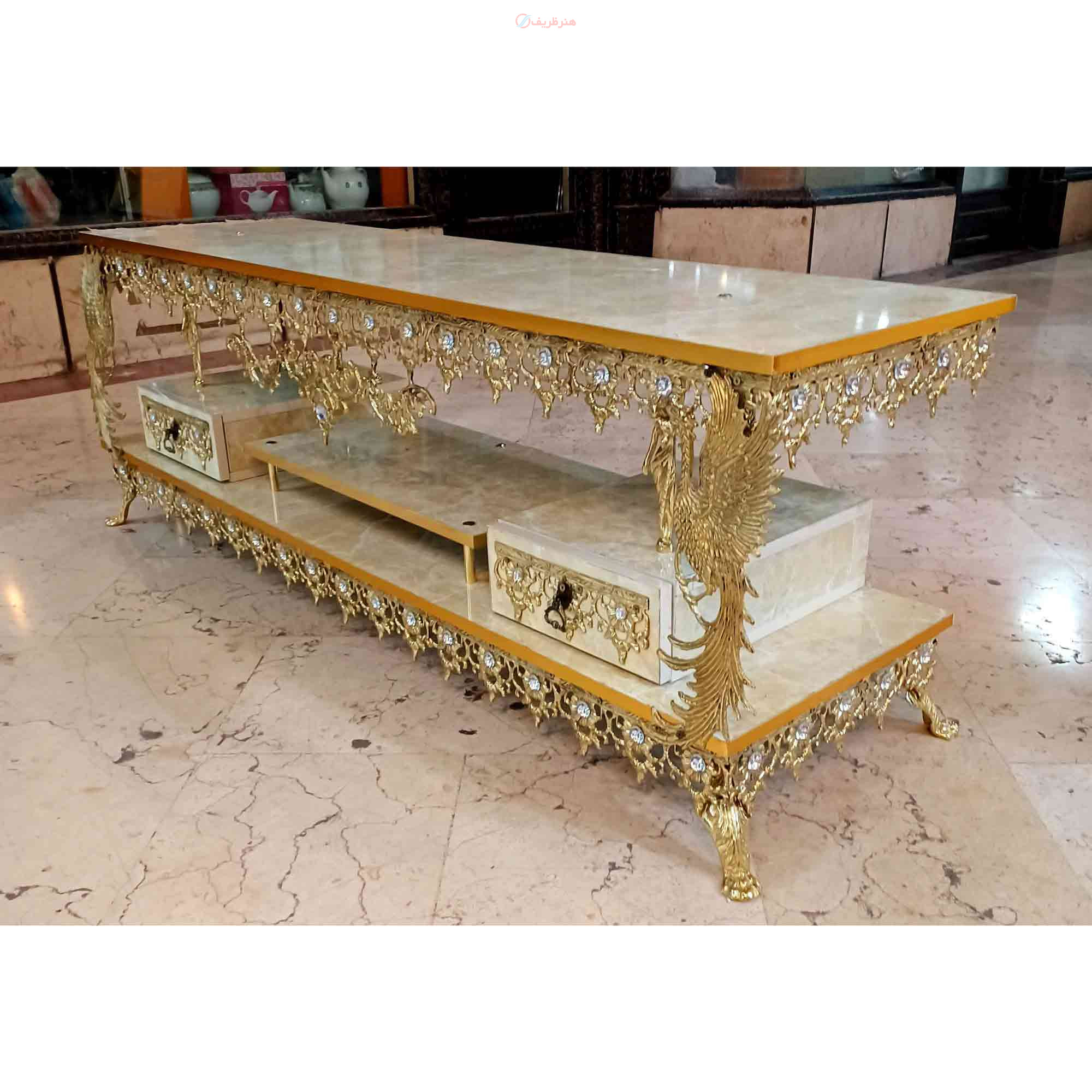 میز تلویزیون برنزی مدل گل آفتابگردان دوکشو طاووس دار
